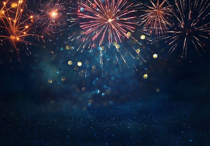 abstract gold, black and blue glitter background with fireworks. christmas eve, 4th of july holiday concept
